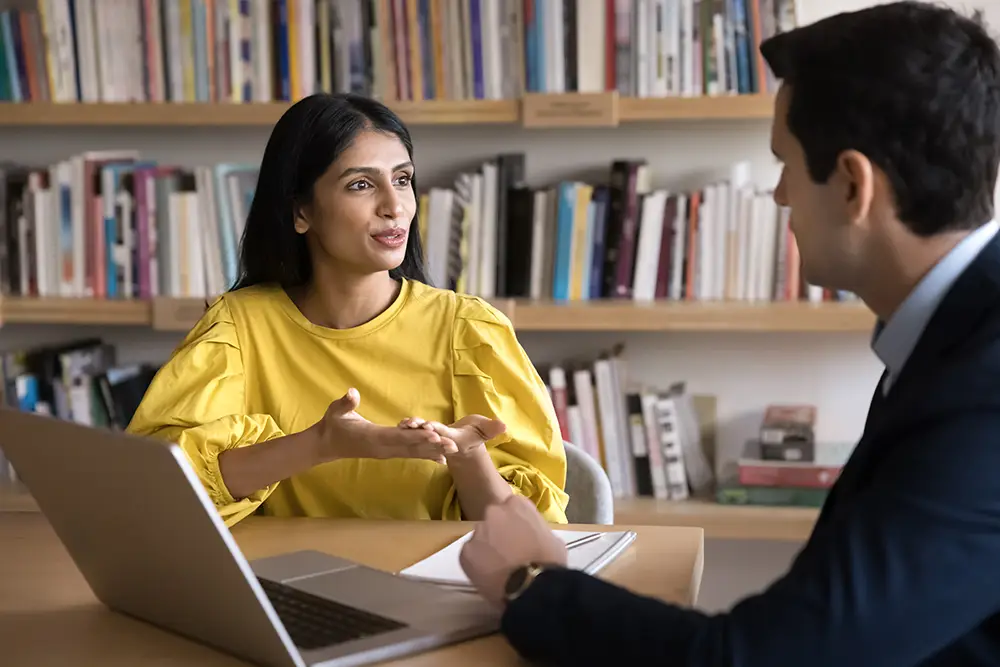 a woman and man meeting together to discuss clinical development consulting